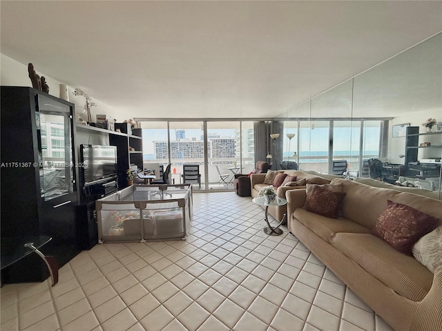 living room featuring a wealth of natural light, floor to ceiling windows, and light tile patterned flooring