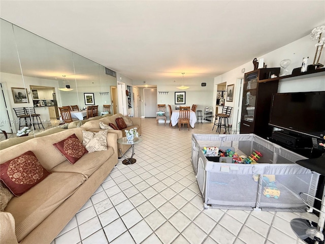 living room with light tile patterned floors and visible vents