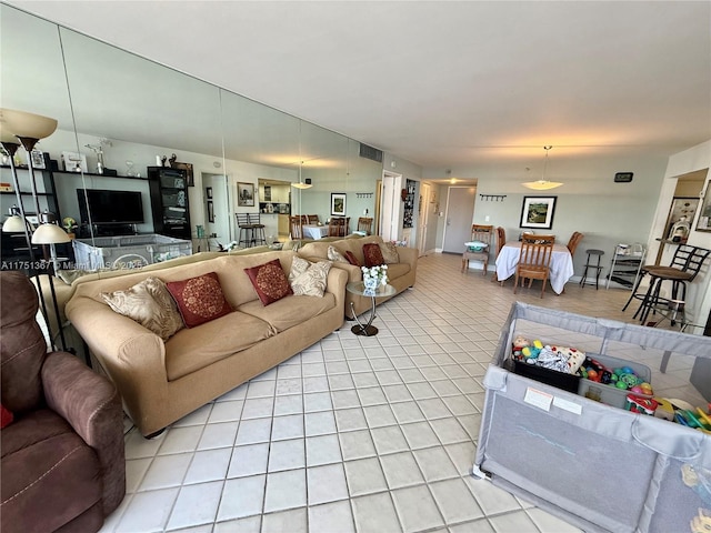 living room featuring visible vents and light tile patterned floors