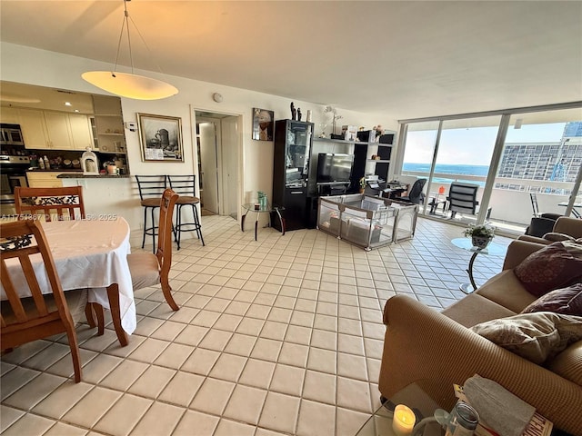 living area featuring light tile patterned floors and floor to ceiling windows