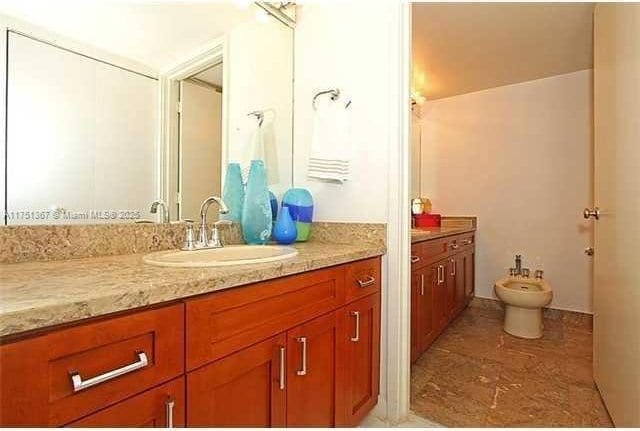 full bathroom with a bidet and vanity