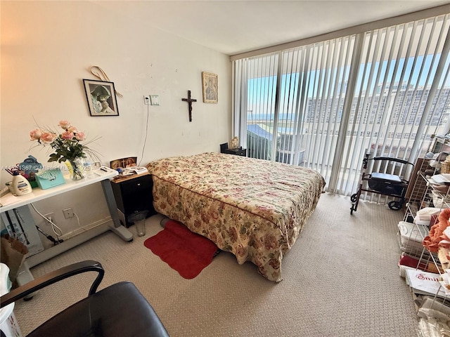 bedroom with carpet, access to outside, and floor to ceiling windows