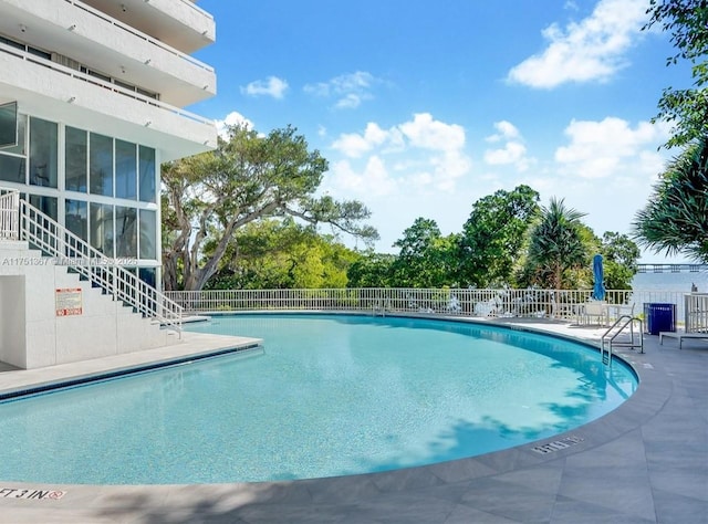 pool featuring fence and stairs