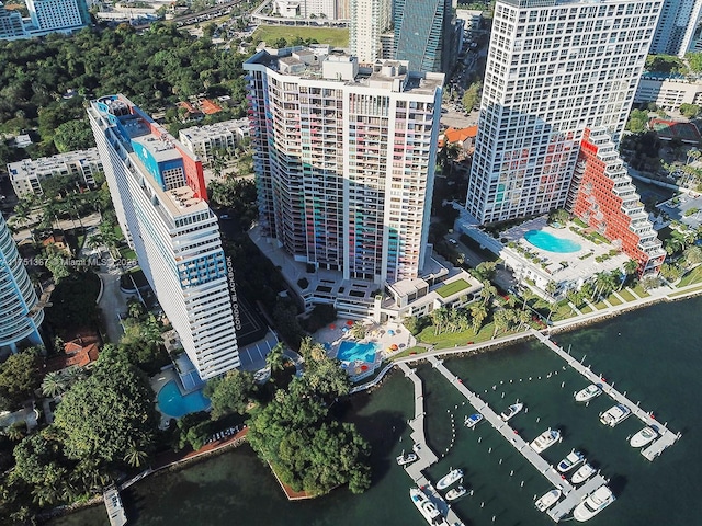 birds eye view of property with a water view and a city view