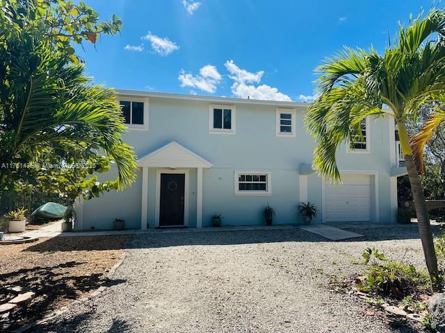 view of front of home with driveway and stucco siding