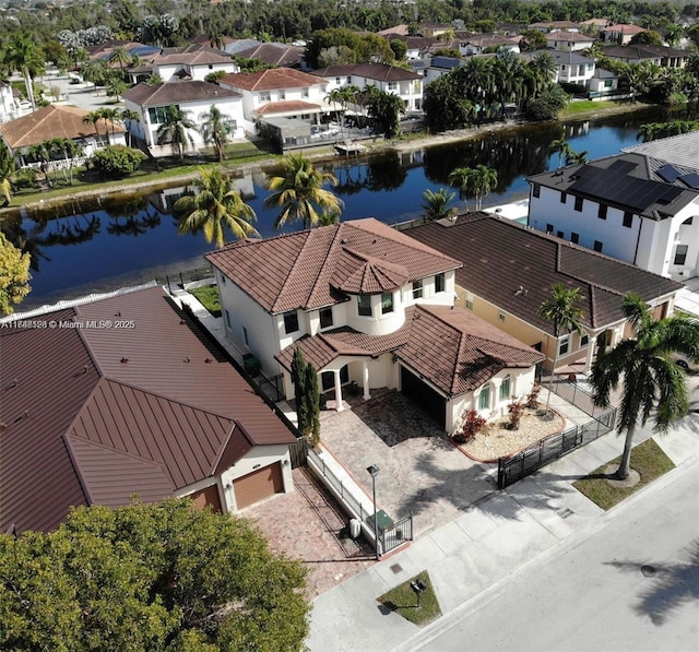 drone / aerial view featuring a residential view and a water view