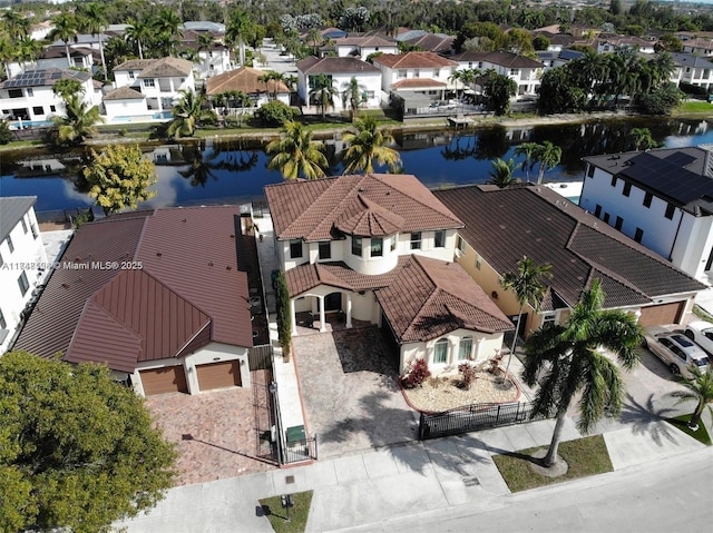 drone / aerial view with a residential view and a water view