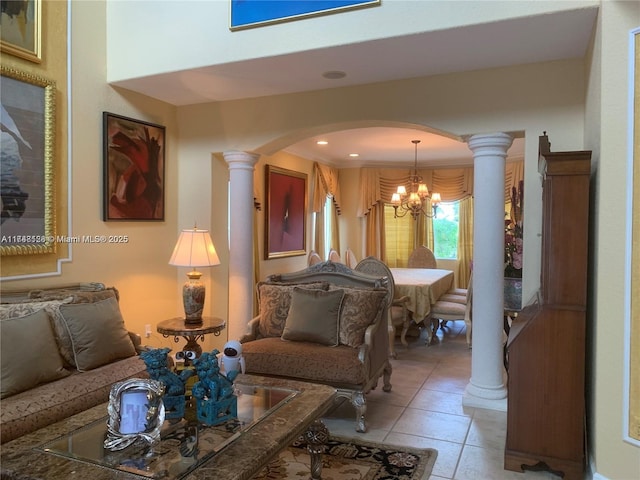 living area with a notable chandelier, light tile patterned floors, arched walkways, and ornate columns