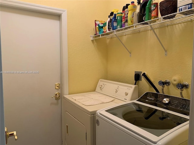 clothes washing area featuring laundry area and washing machine and dryer