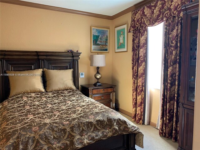 bedroom with baseboards, carpet floors, and ornamental molding