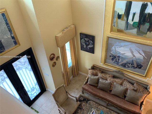 foyer entrance featuring light tile patterned floors and baseboards