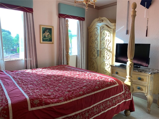 bedroom featuring crown molding and carpet floors