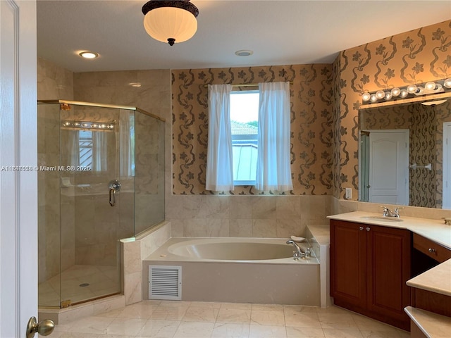 full bathroom featuring visible vents, a shower stall, wallpapered walls, a bath, and vanity