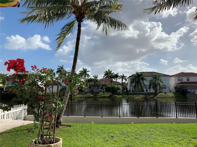 view of yard with a water view and fence