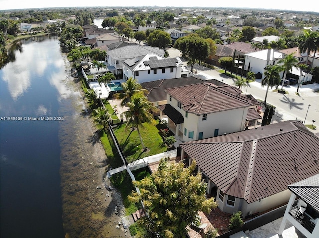 drone / aerial view with a residential view and a water view