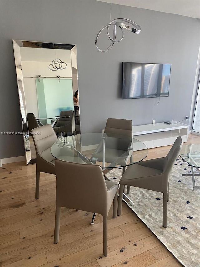 dining area featuring hardwood / wood-style floors and baseboards