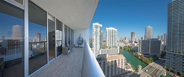 balcony with a view of city and a water view