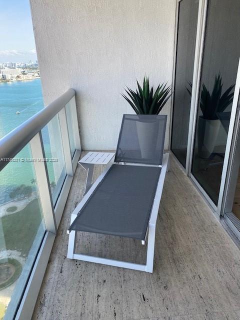 balcony featuring a water view