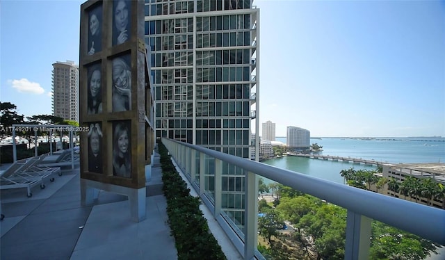 balcony featuring a water view, central AC, and a city view