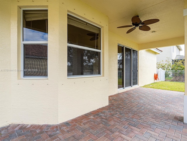 view of patio / terrace featuring fence and a ceiling fan