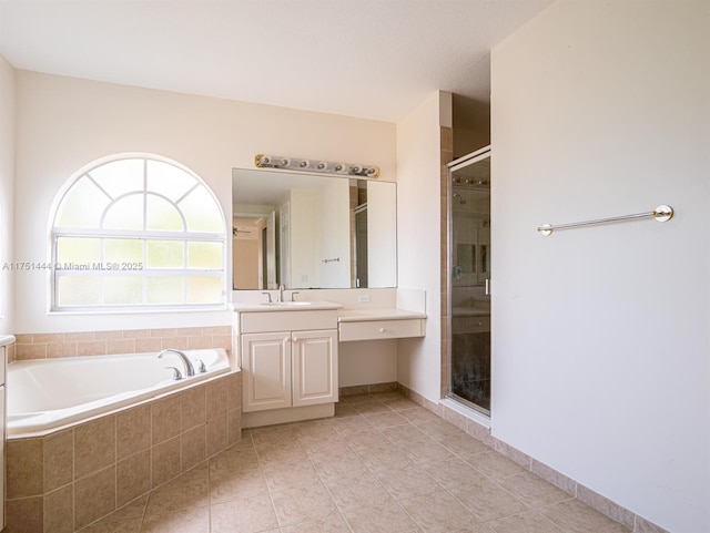 bathroom featuring a shower stall, vanity, tile patterned flooring, baseboards, and a bath