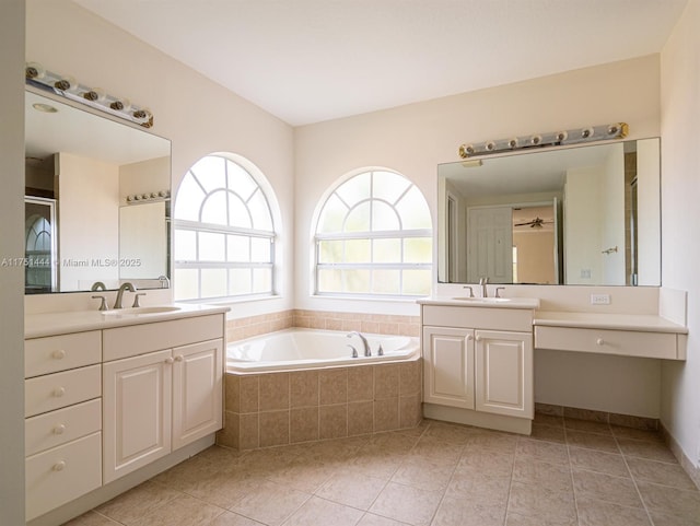 full bathroom with a garden tub, two vanities, a sink, and tile patterned floors