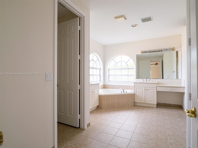 bathroom with visible vents, vanity, tile patterned flooring, and a bath