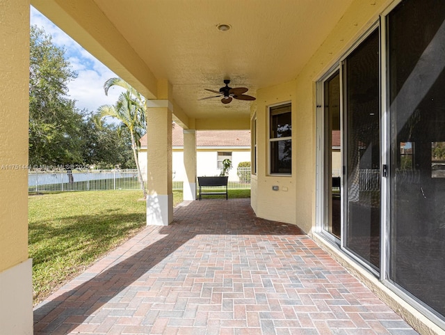 view of patio / terrace featuring ceiling fan and fence