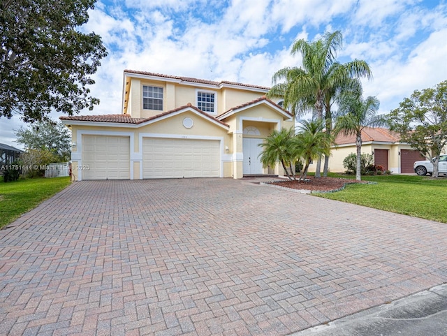 view of front of property featuring decorative driveway, stucco siding, an attached garage, a tiled roof, and a front lawn