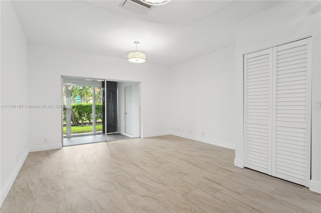 empty room featuring visible vents and baseboards