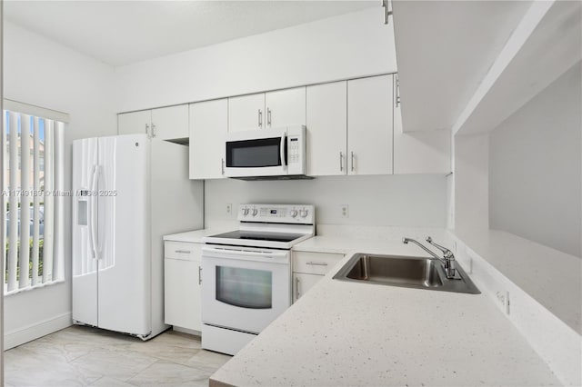 31 Whitehead Cir, Weston, FL 33326 - kitchen featuring white appliances, white cabinetry, a sink, and marble finish floor