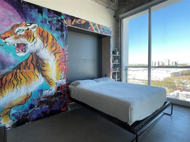 bedroom featuring a view of city and concrete floors