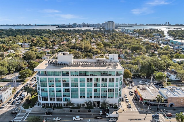 drone / aerial view featuring a view of city and a water view