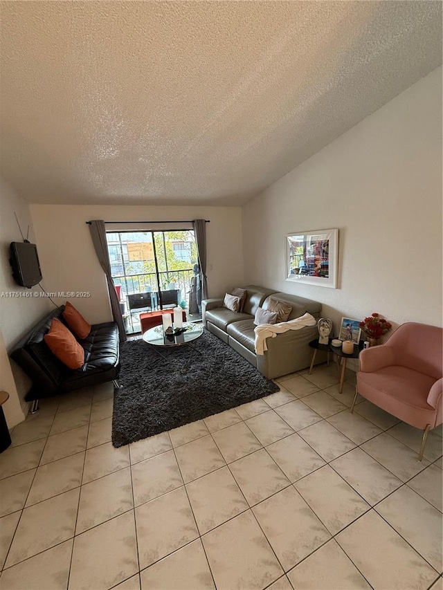 living area with lofted ceiling, a textured ceiling, and light tile patterned flooring