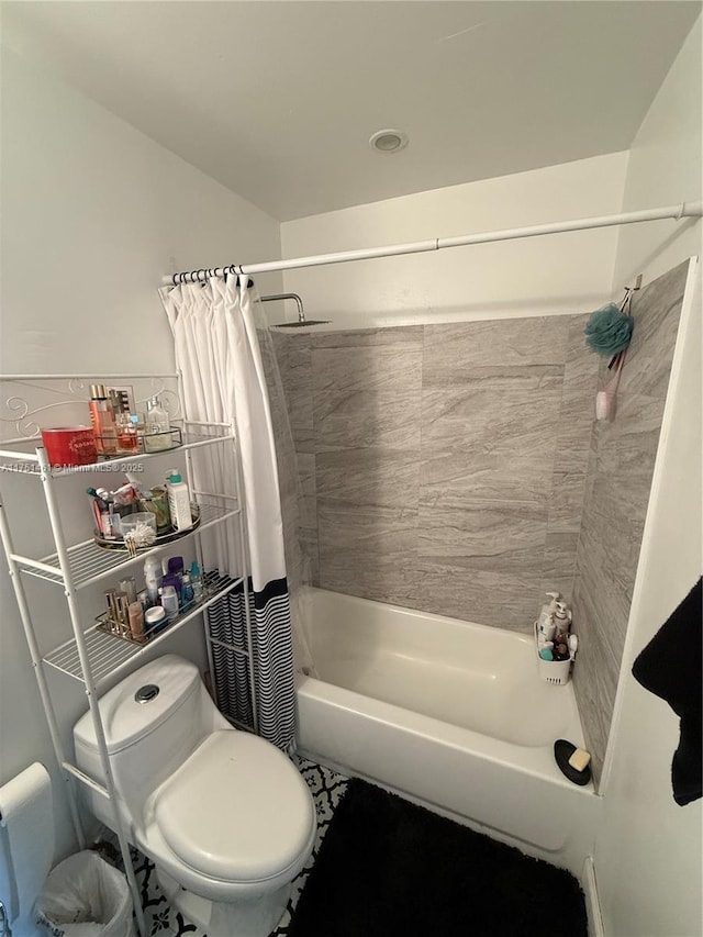 bathroom with shower / bath combination with curtain and toilet