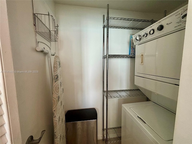 washroom with stacked washer and clothes dryer and laundry area