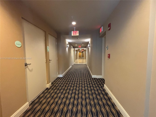 hallway with baseboards and carpet flooring