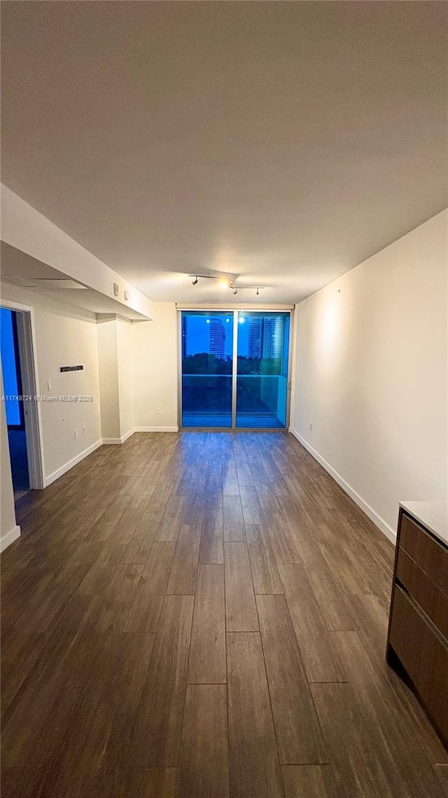 1600 SW 1st Ave Unit 703, Miami, FL 33129 - unfurnished room featuring dark wood finished floors, track lighting, and baseboards