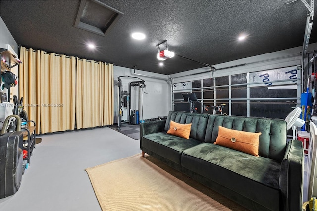 cinema room with a garage, a textured ceiling, and finished concrete flooring