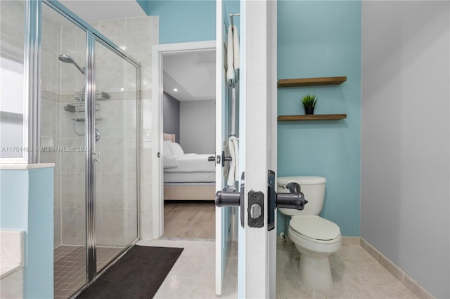 ensuite bathroom with a stall shower, baseboards, connected bathroom, toilet, and tile patterned flooring