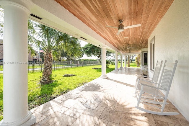 view of patio with fence and a ceiling fan