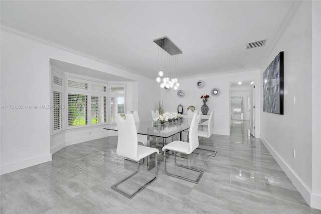 dining space with baseboards, a notable chandelier, visible vents, and crown molding