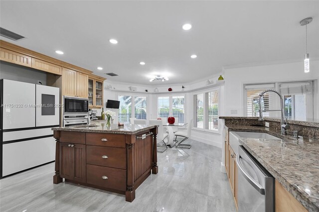 kitchen with a sink, hanging light fixtures, freestanding refrigerator, dishwasher, and glass insert cabinets