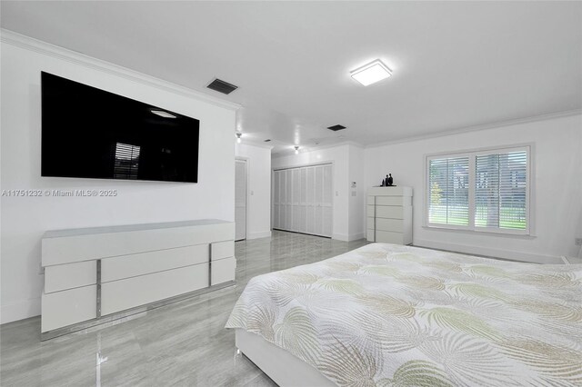 bedroom featuring baseboards, a closet, visible vents, and crown molding