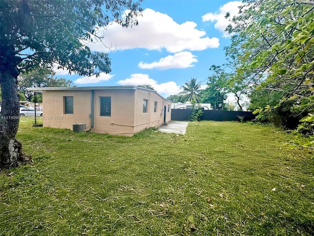 view of yard featuring fence and cooling unit