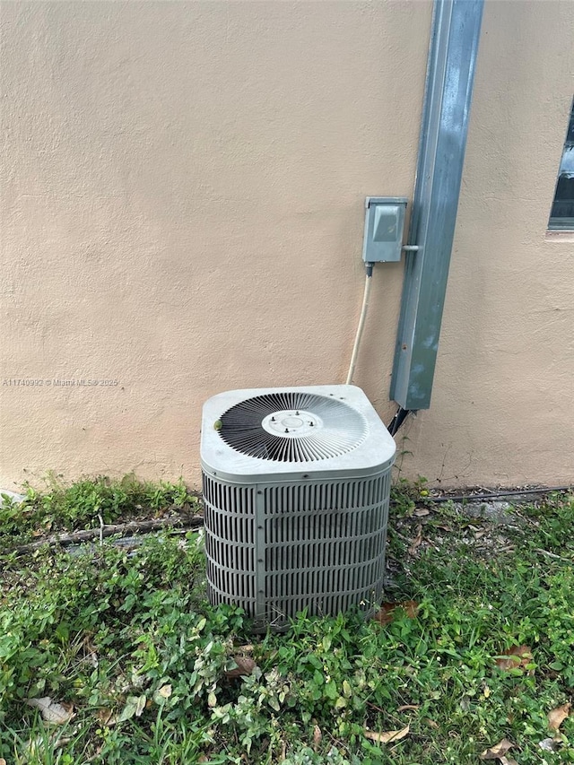 details with cooling unit and stucco siding