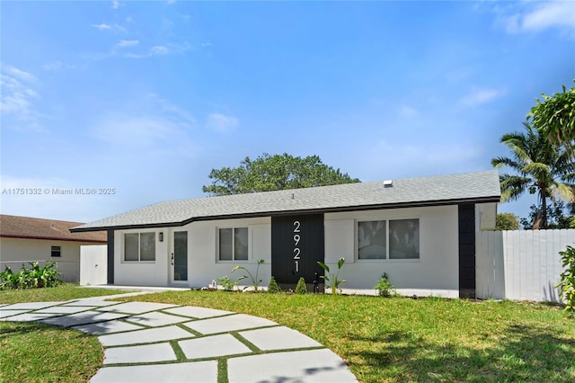 ranch-style house with roof with shingles