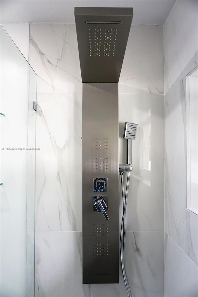 bathroom with a marble finish shower