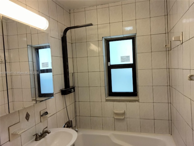 full bath featuring a sink and tile walls