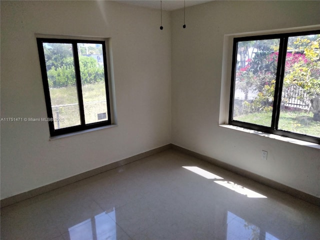 unfurnished room featuring baseboards